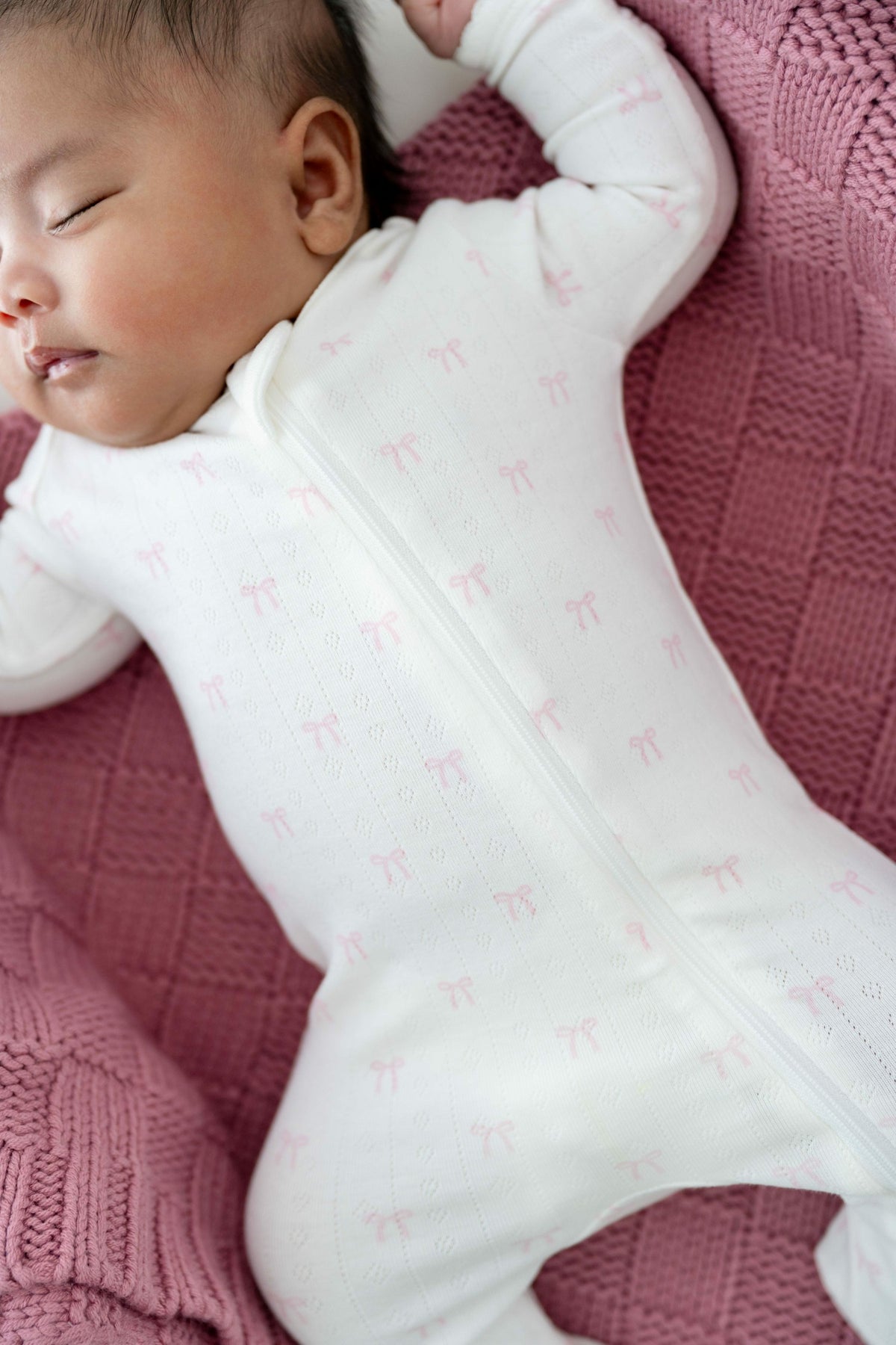 Pointelle Zippered Footie in Sweet Pink Bow | Kyte Baby