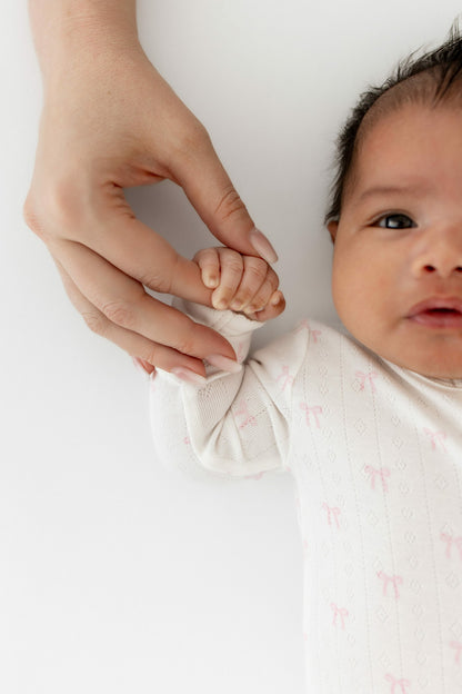 Pointelle Zippered Footie in Sweet Pink Bow | Kyte Baby