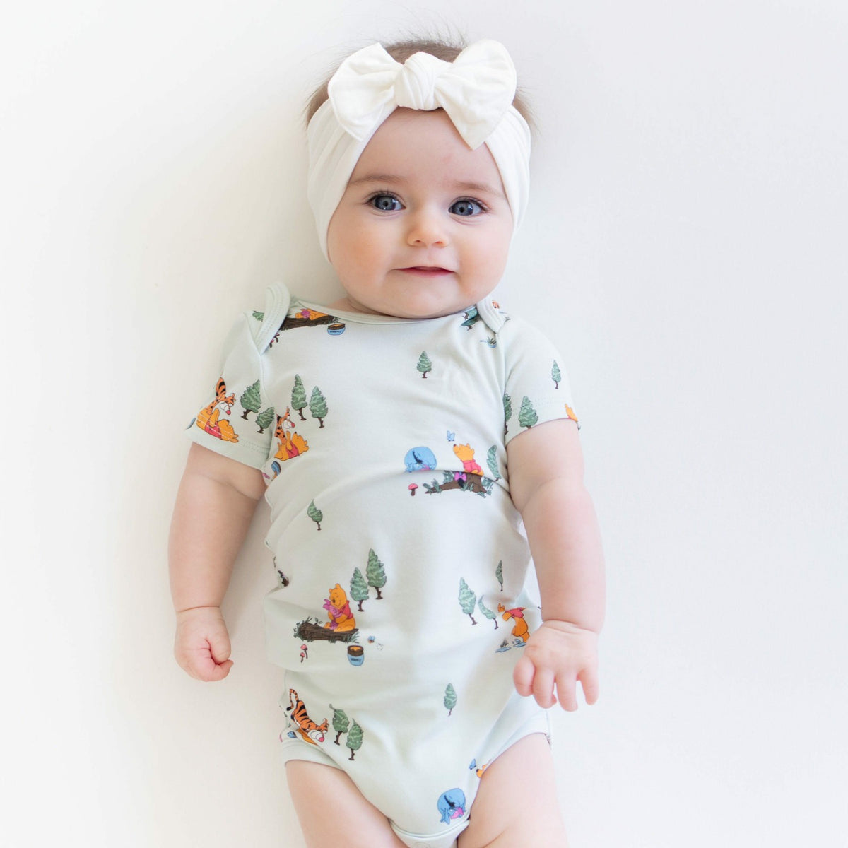 Bodysuit in Winnie the Pooh Hundred Acre Wood | Kyte Baby