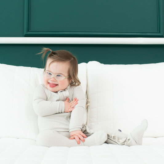 Ribbed Ruffle Bamboo Zipper Footie in Oat | Kyte Baby
