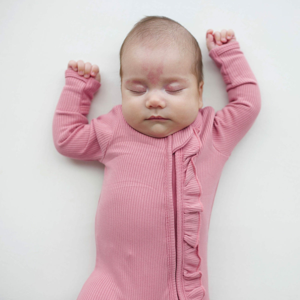 Ribbed Ruffle Zipper Footie in Apple Blossom | Kyte Baby