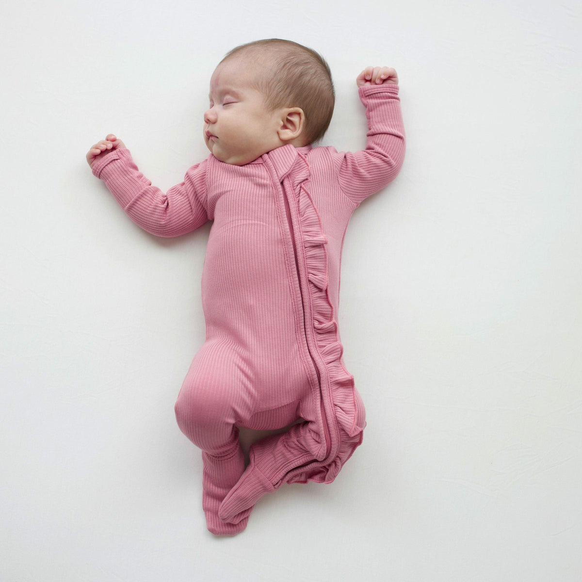 Ribbed Ruffle Zipper Footie in Apple Blossom | Kyte Baby