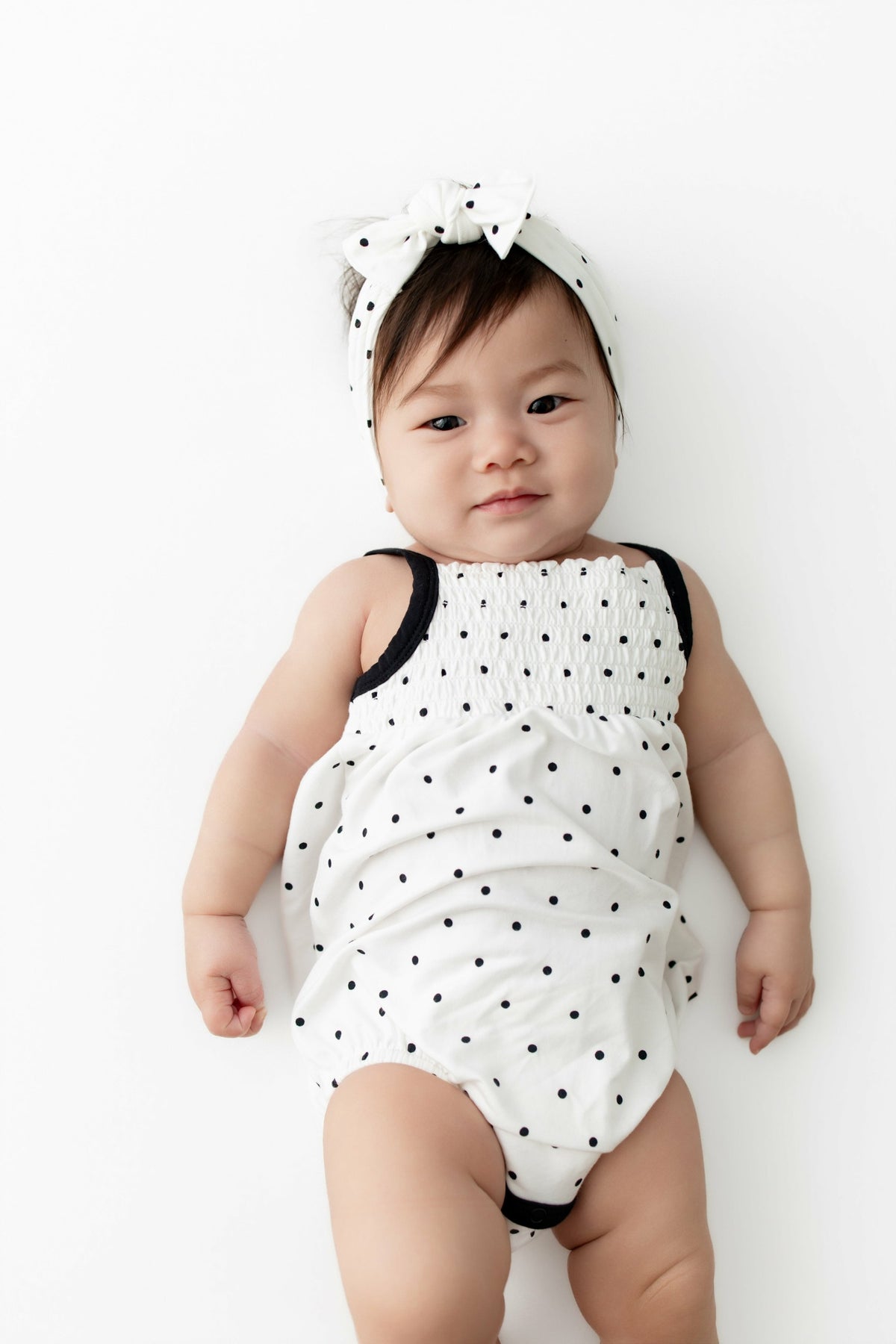 Smocked Bubble Romper in Midnight Polka Dot | Kyte Baby