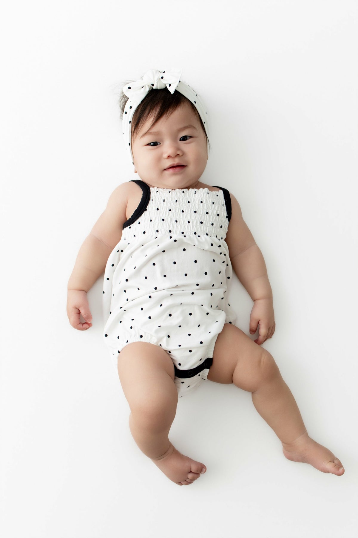 Smocked Bubble Romper in Midnight Polka Dot | Kyte Baby